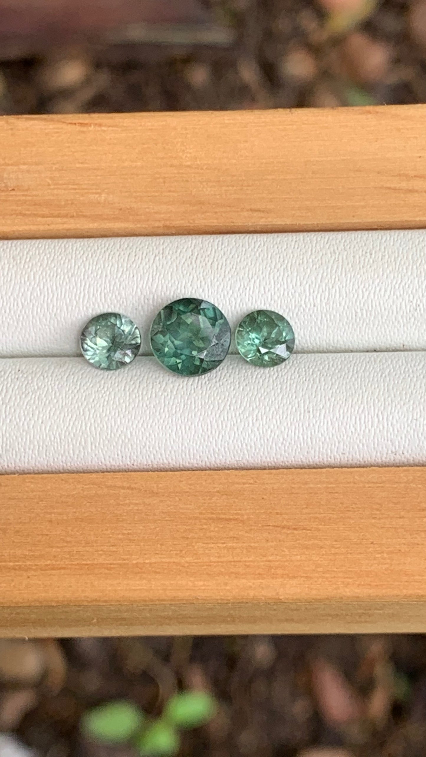 close up green Australian sapphire trilogy set 2.15ct total weight loose gemstones
