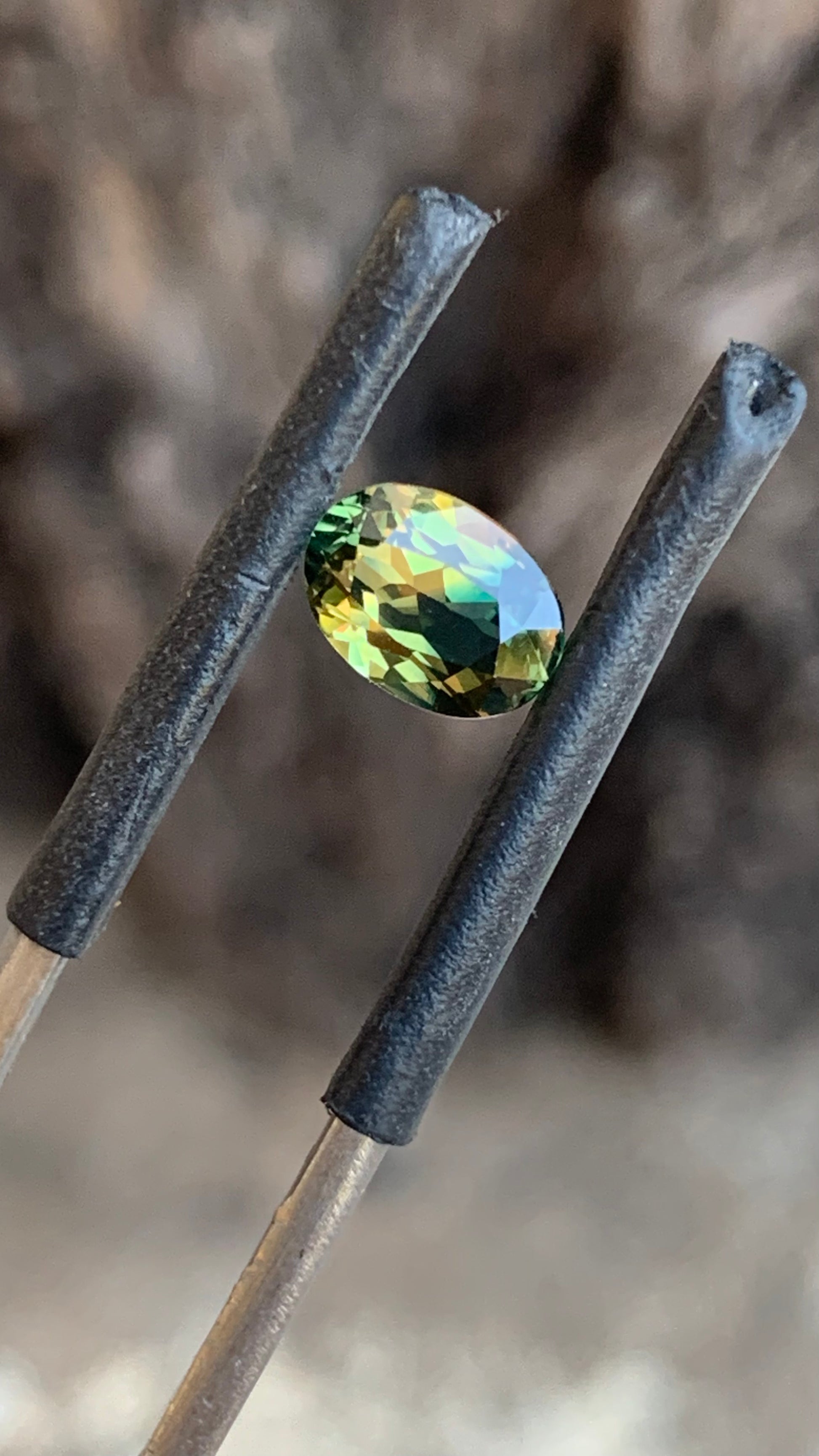 Oval Australian sapphire with striking green orange colour play