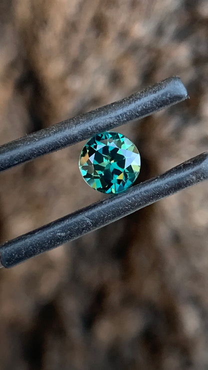 Eye clean round Australian sapphire with rich dark teal colour