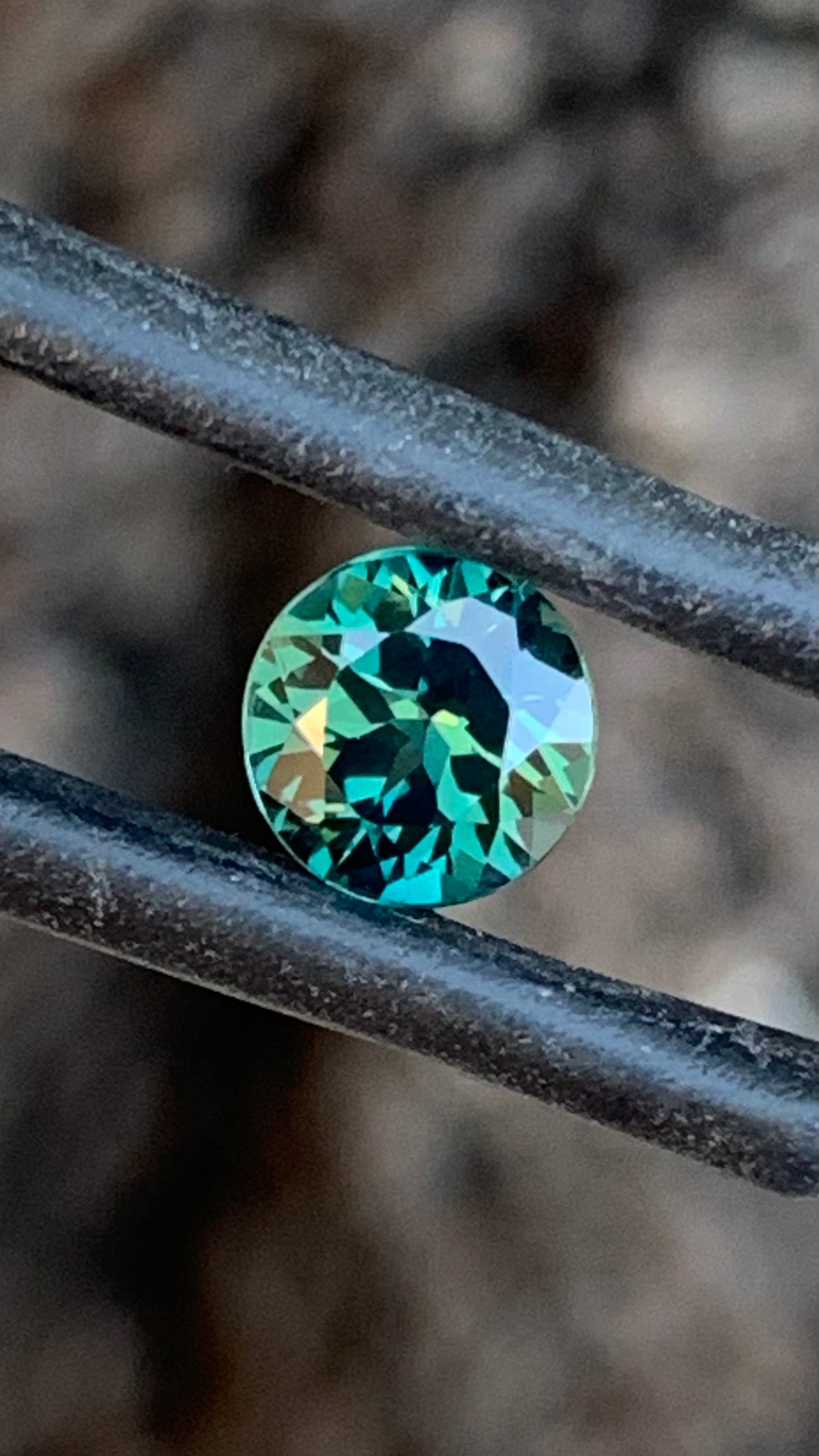 1.01ct dark teal Australian sapphire round cut from the Central Queensland Gemfields