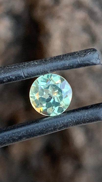 0.91ct pale pastel green Australian sapphire round cut with icy blue undertones