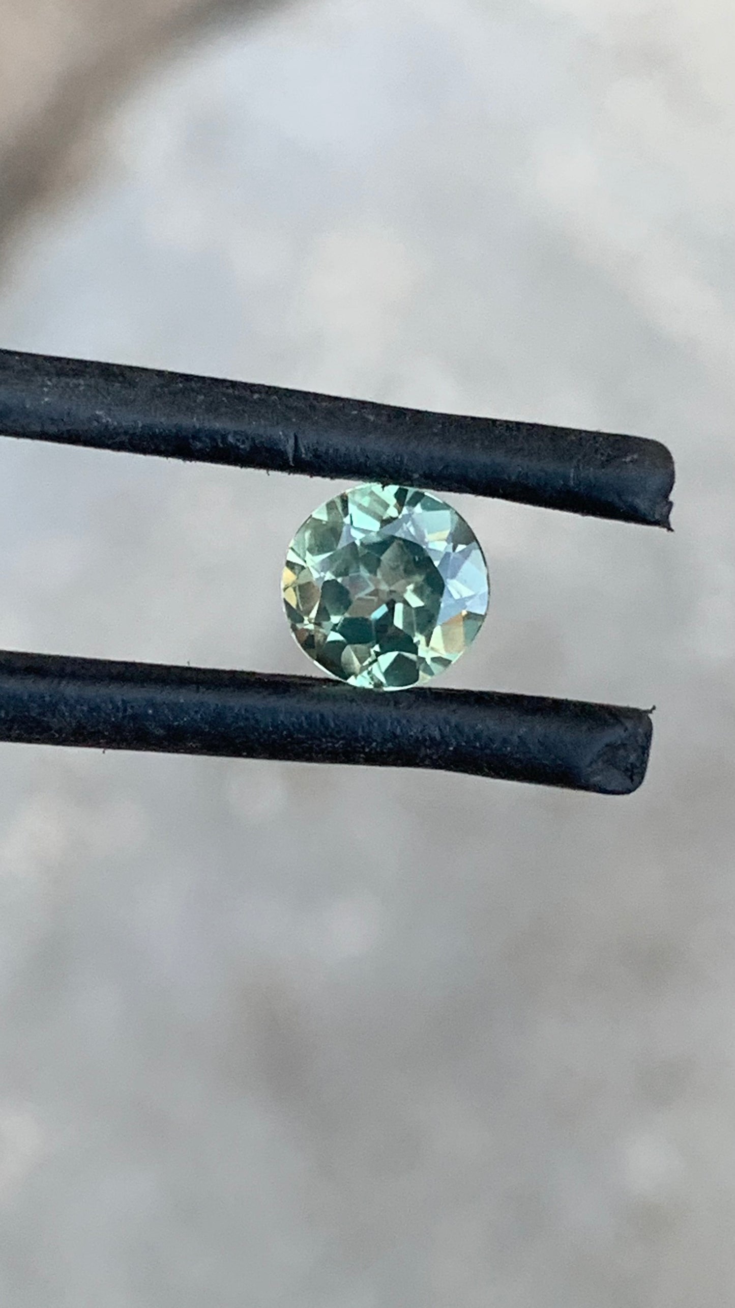 Round Australian sapphire with delicate pastel green blue tones