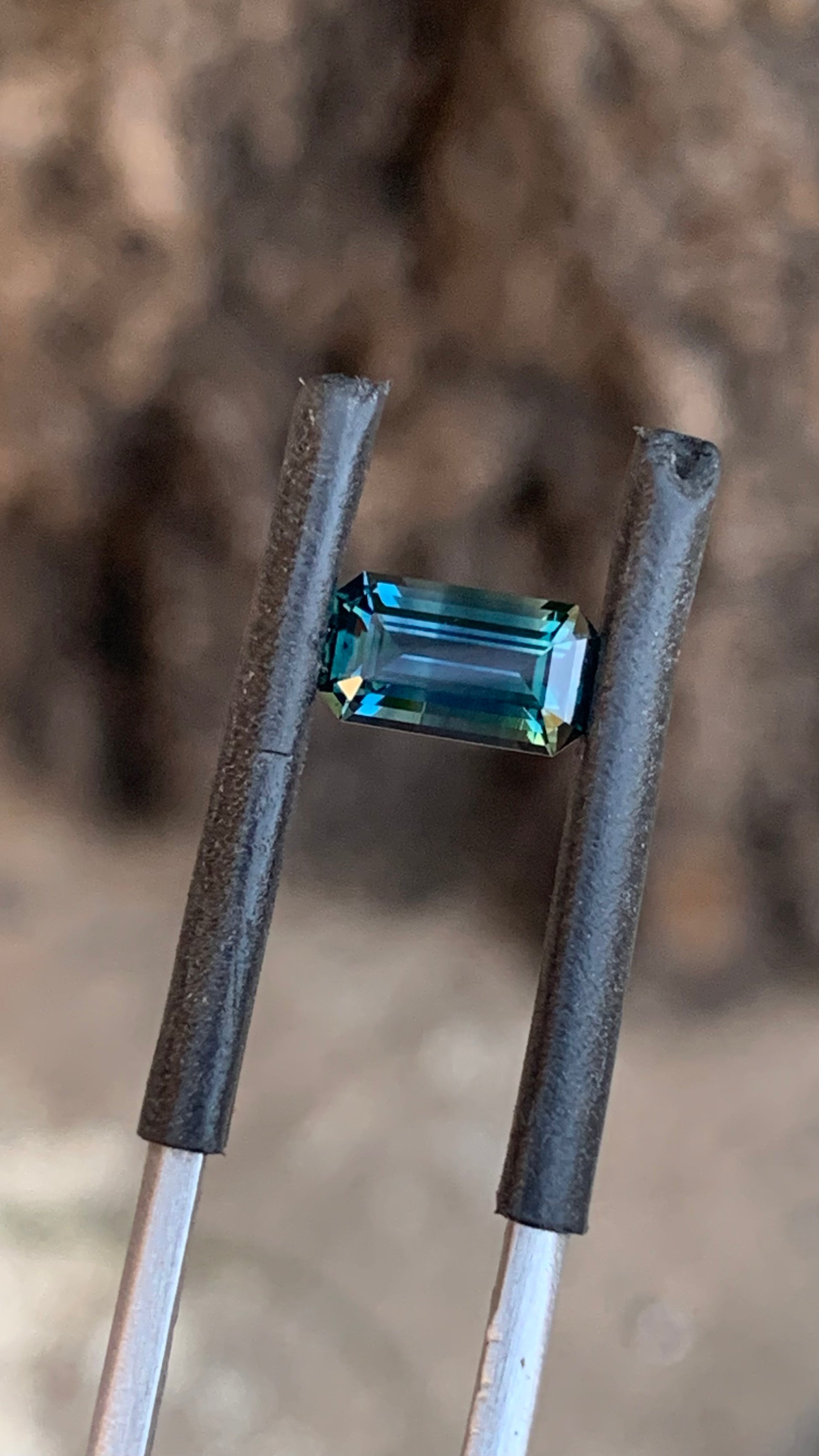 Natural Australian sapphire with darker blue side and subtle yellow zoning
