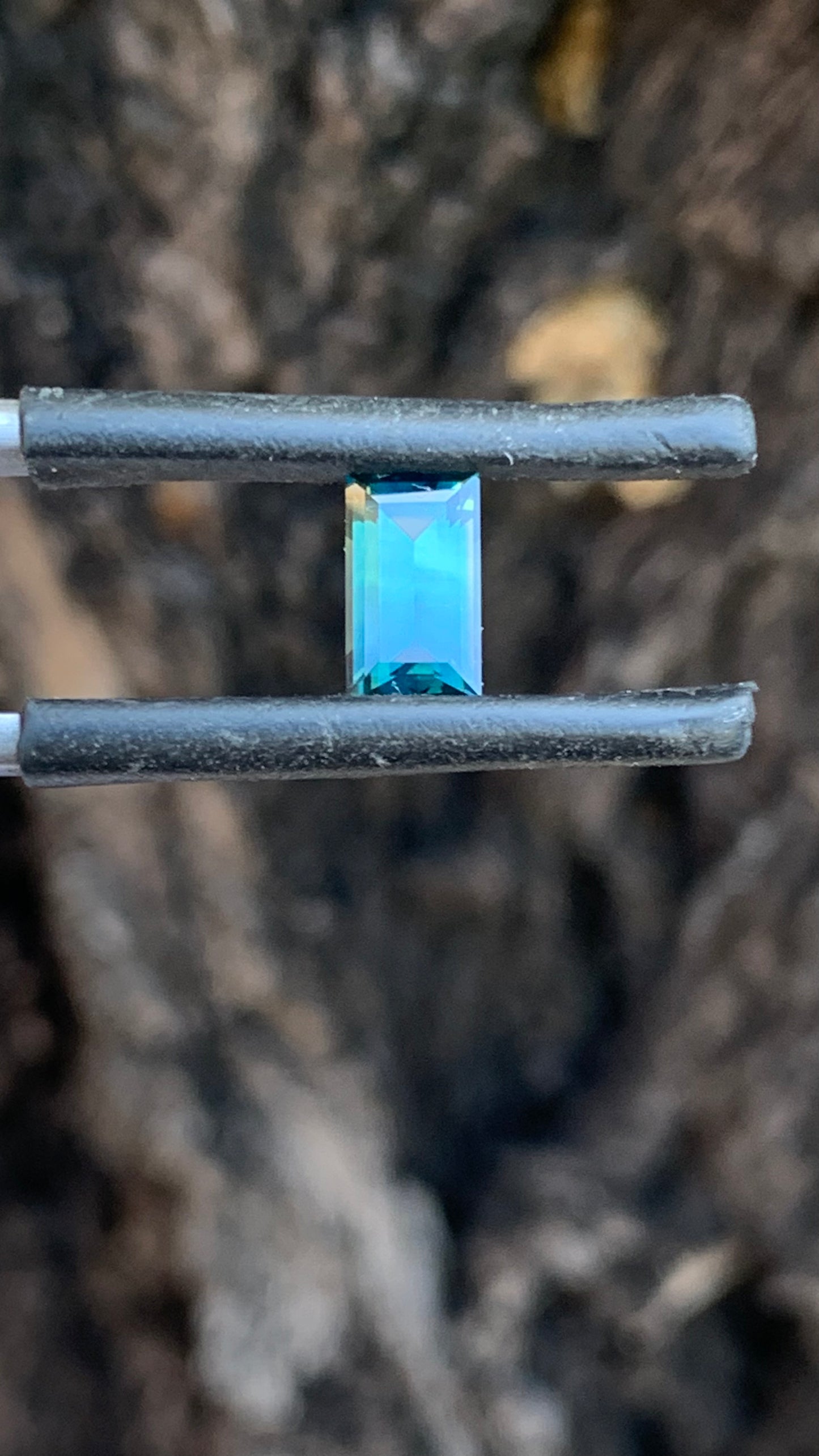 Eye clean baguette cut Australian sapphire with soft green and blue tones