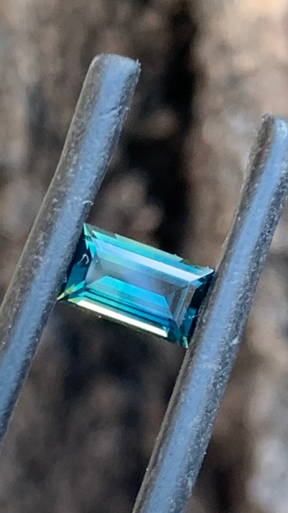 Natural Australian sapphire with subtle smoky green blue colour and baguette cut