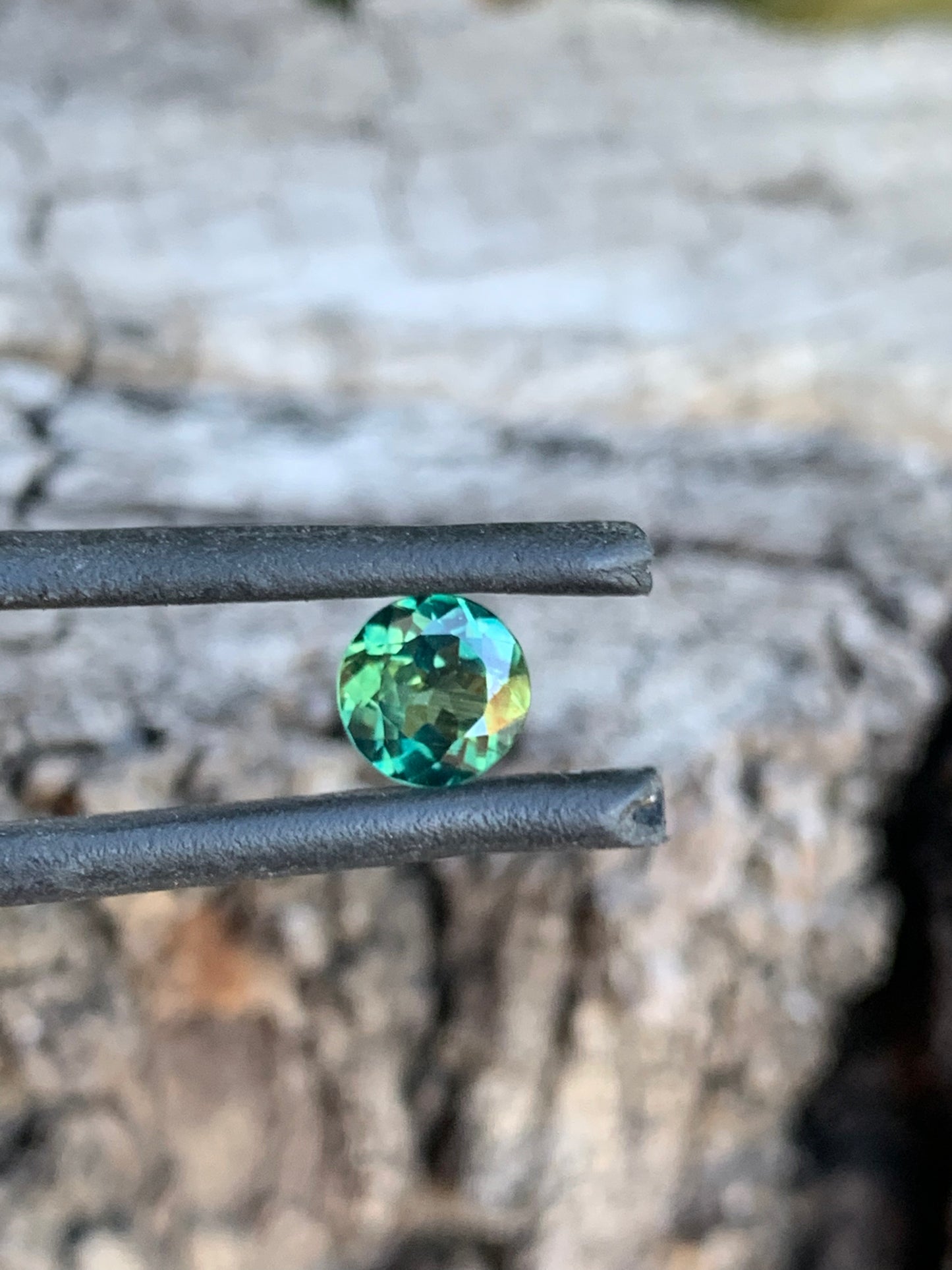 Round cut Australian sapphire with teal colour variation