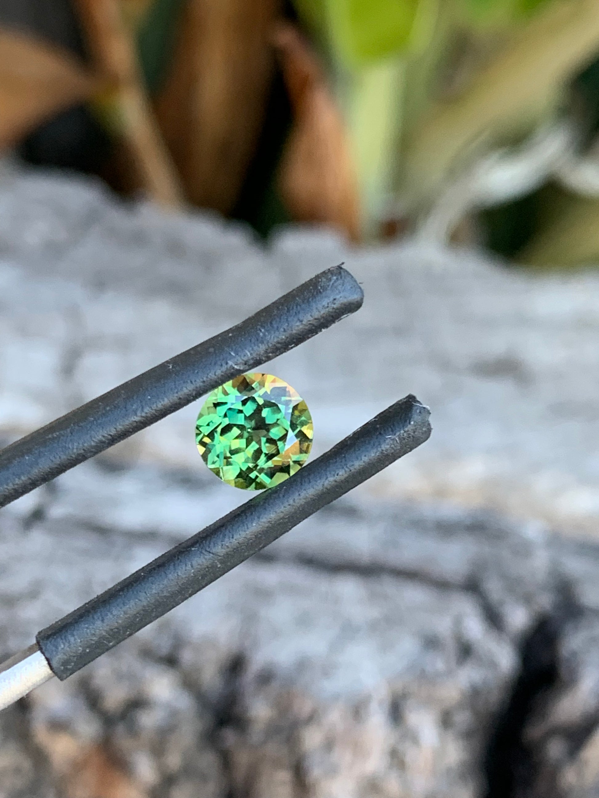 Close-up of 1.01ct light green sapphire showing vibrant colour