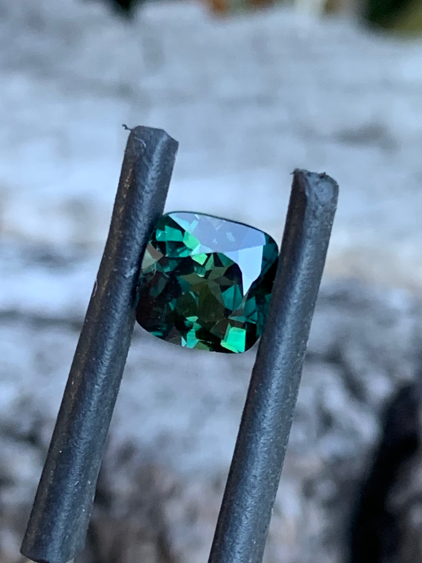 Close-up of 1.91ct teal parti sapphire showing blue, green and yellow tones