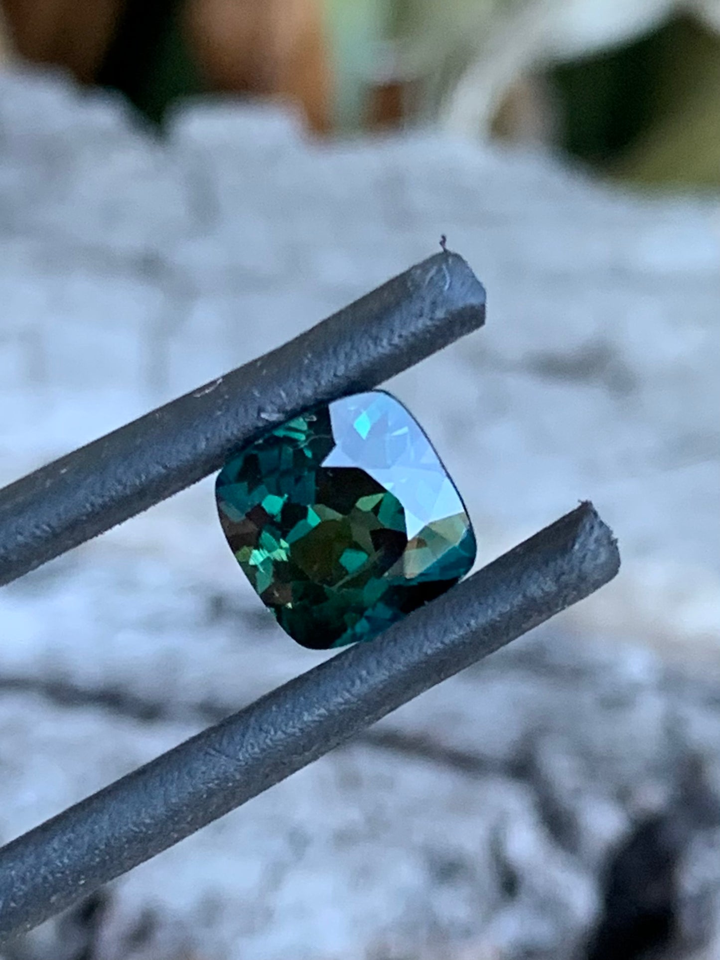 Teal parti sapphire with flashes of yellow and green hues