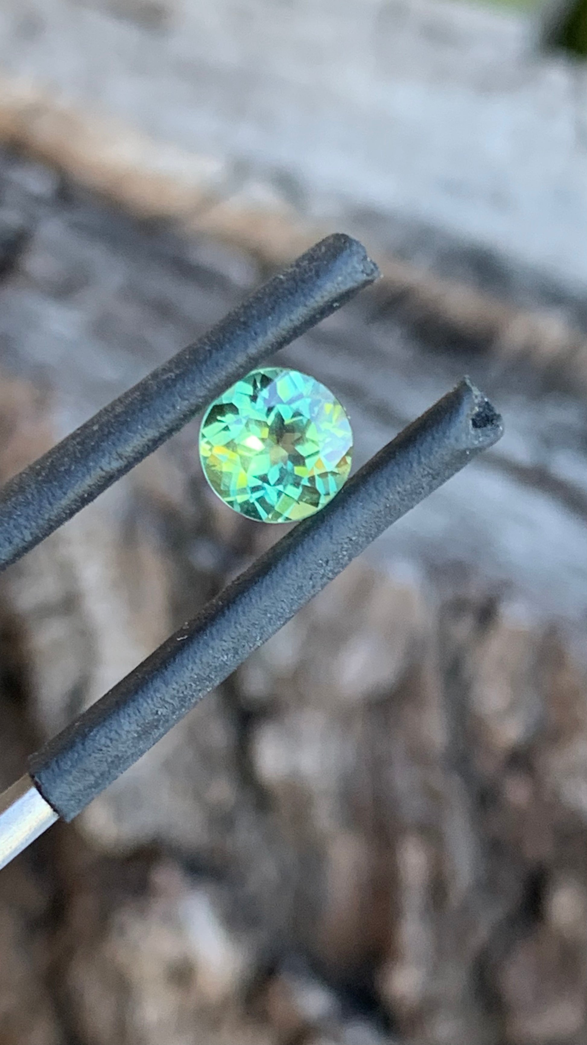 Close up of Bright teal and yellow Australian parti sapphire, 0.99ct