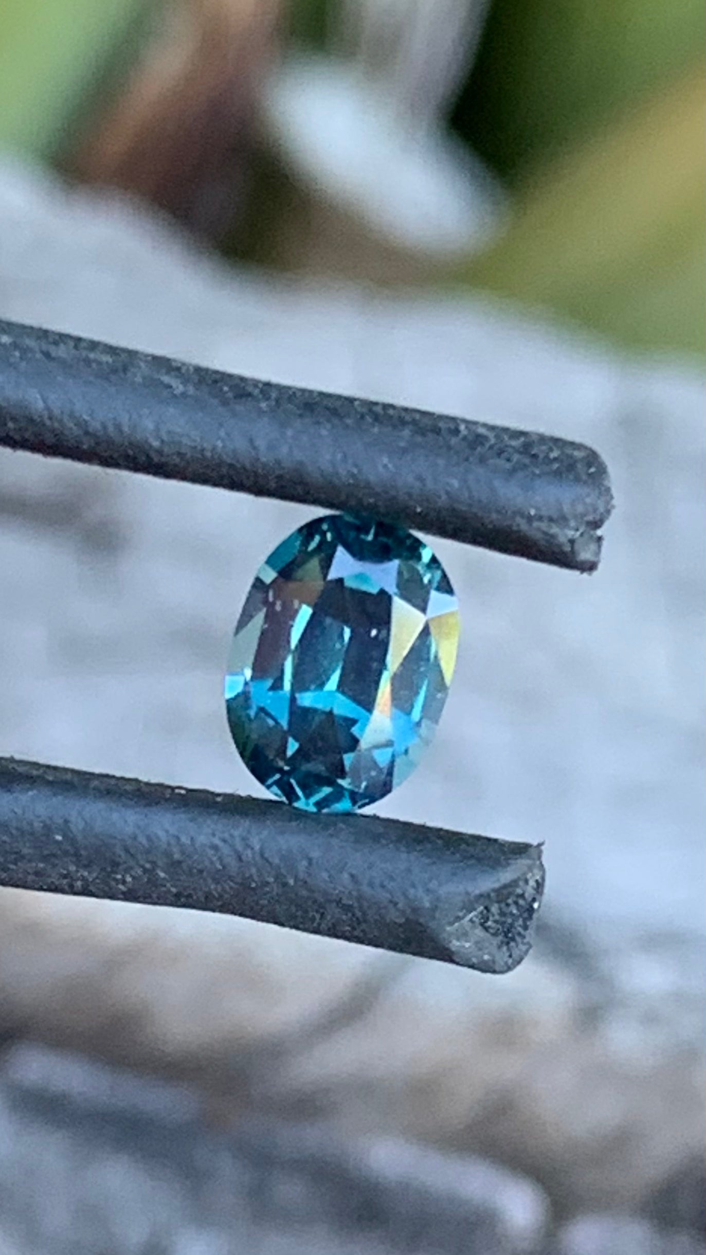 Close up of Teal blue Australian sapphire with yellow tones, 0.71ct