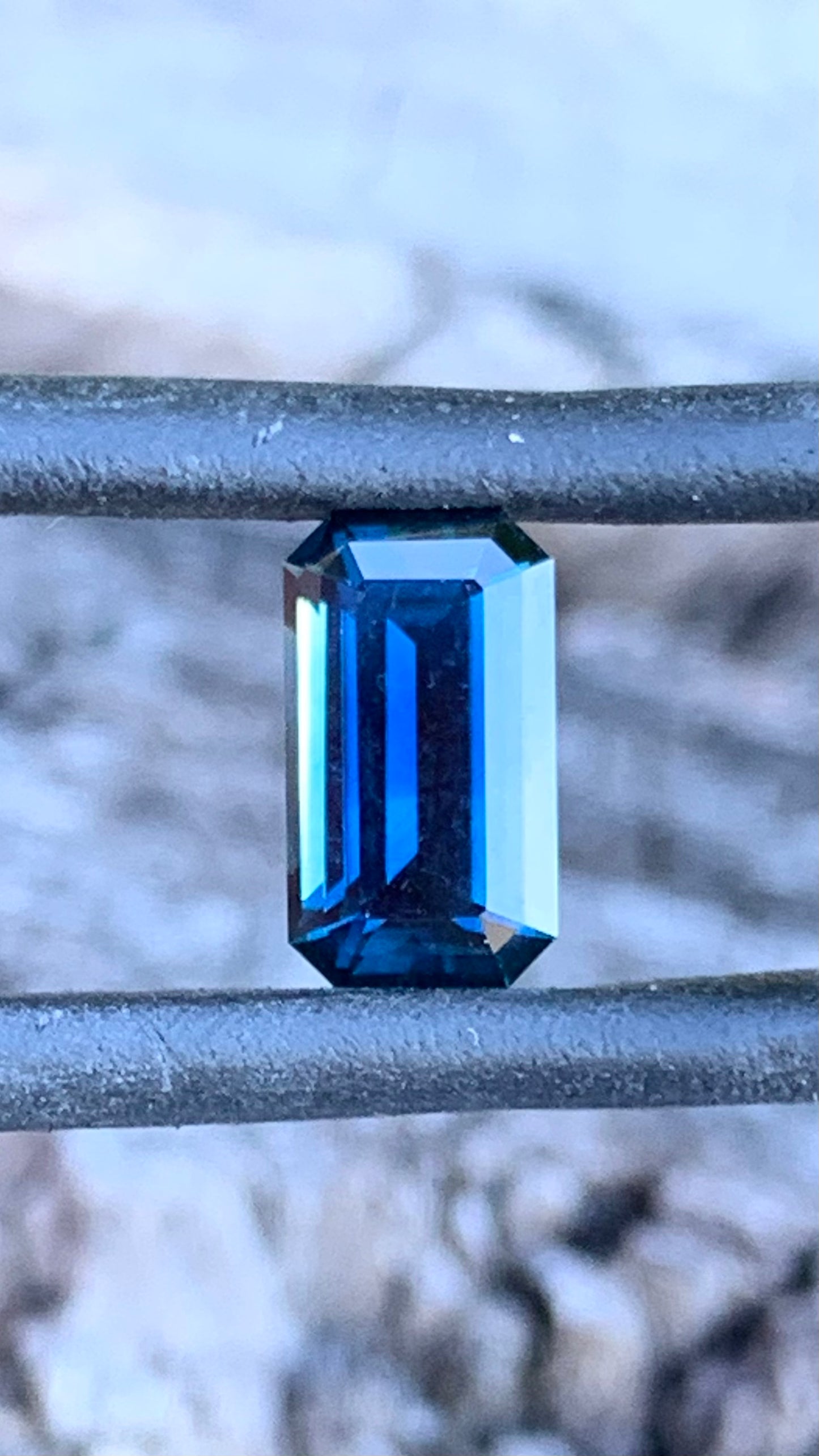 Close up of Dark blue emerald cut Australian sapphire, 1.53ct