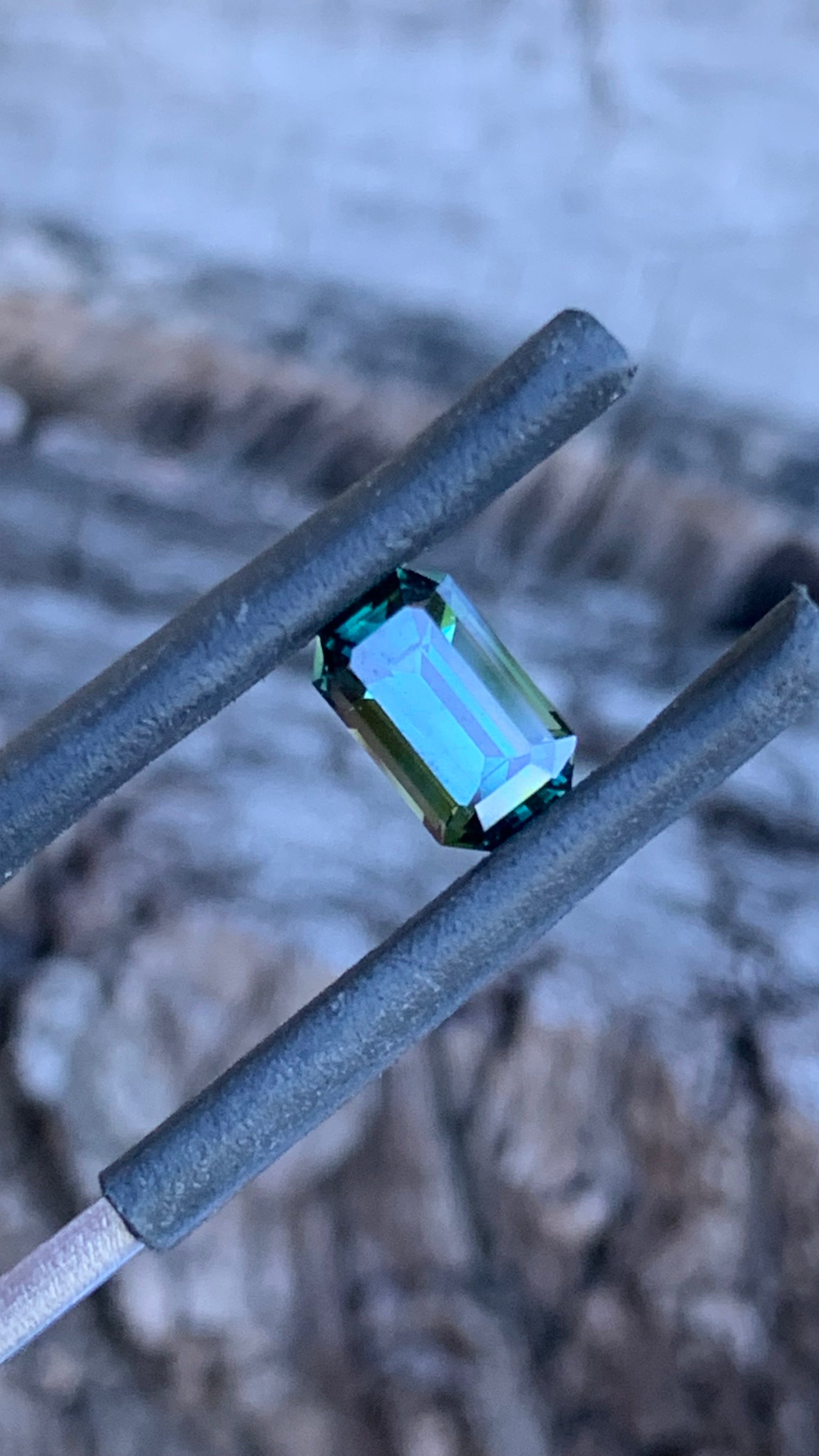 Close up of Teal emerald cut Australian parti sapphire, 1.09ct