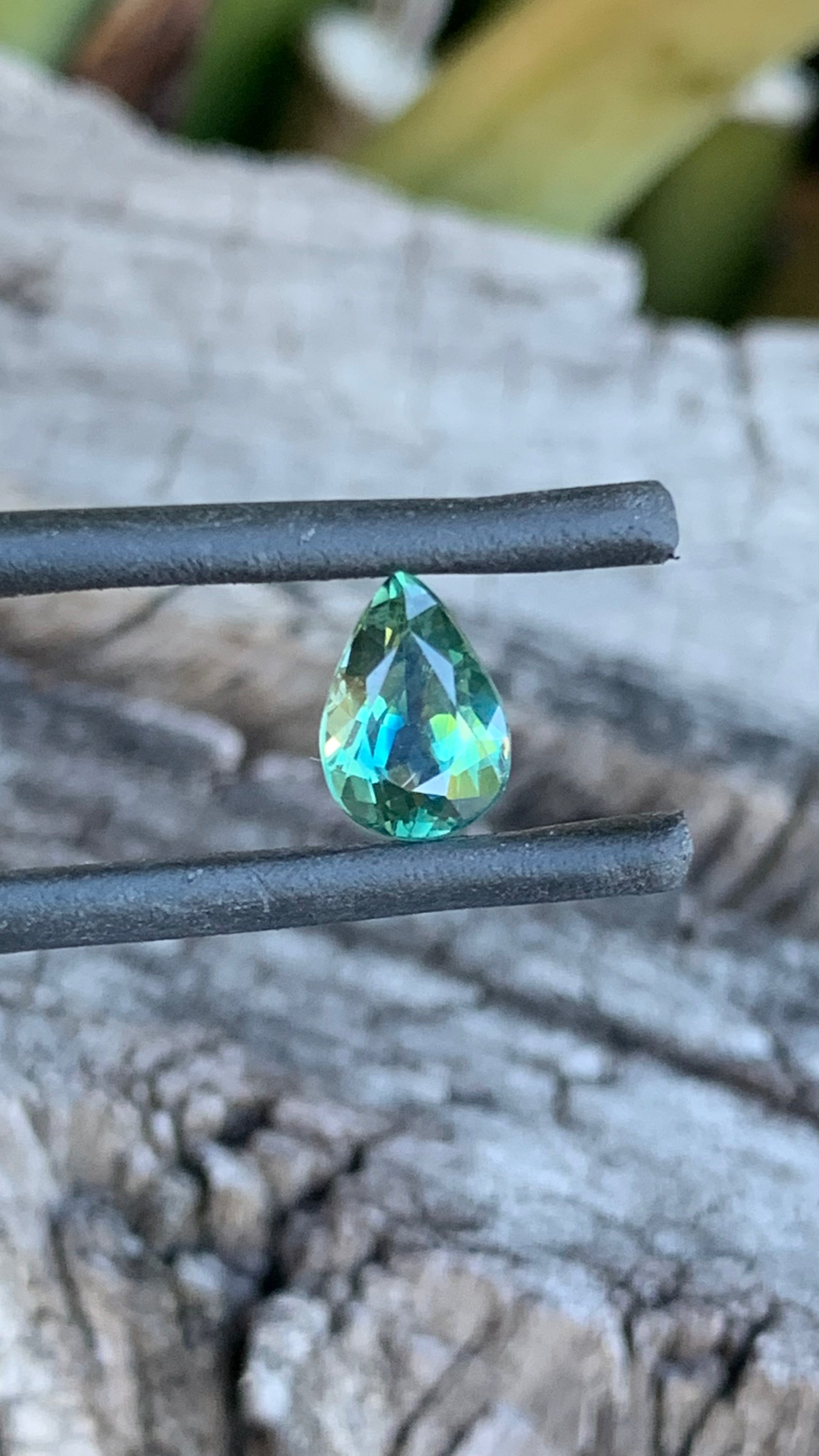 Close up ofear shaped seafoam teal Australian sapphire, 1.40ct