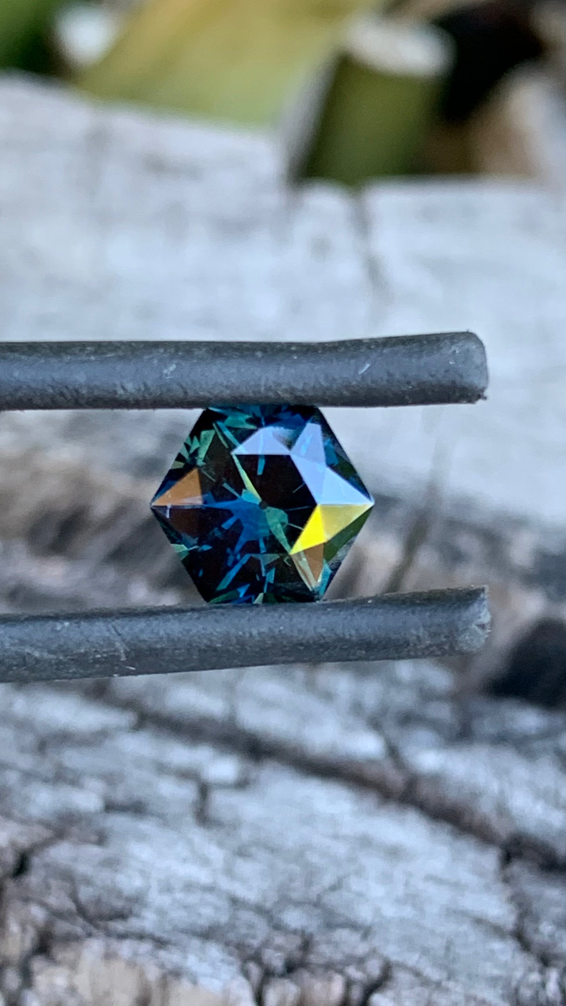 1.74ct hexagon cut Australian parti sapphire with dark colour and internal flashes