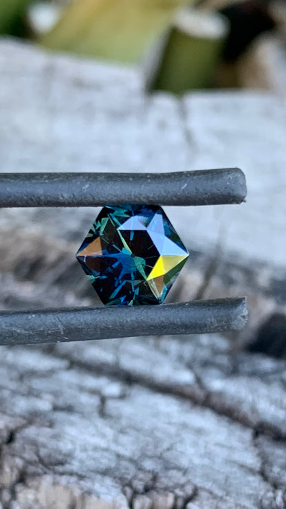 1.74ct hexagon cut Australian parti sapphire with dark colour and internal flashes