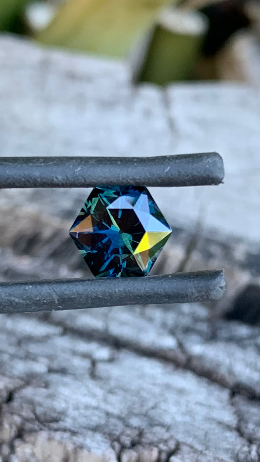 1.74ct hexagon cut Australian parti sapphire with dark colour and internal flashes