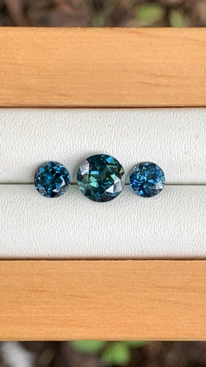 Close up of blue parti centre Australian sapphire trilogy set with blue accents 2.00ct