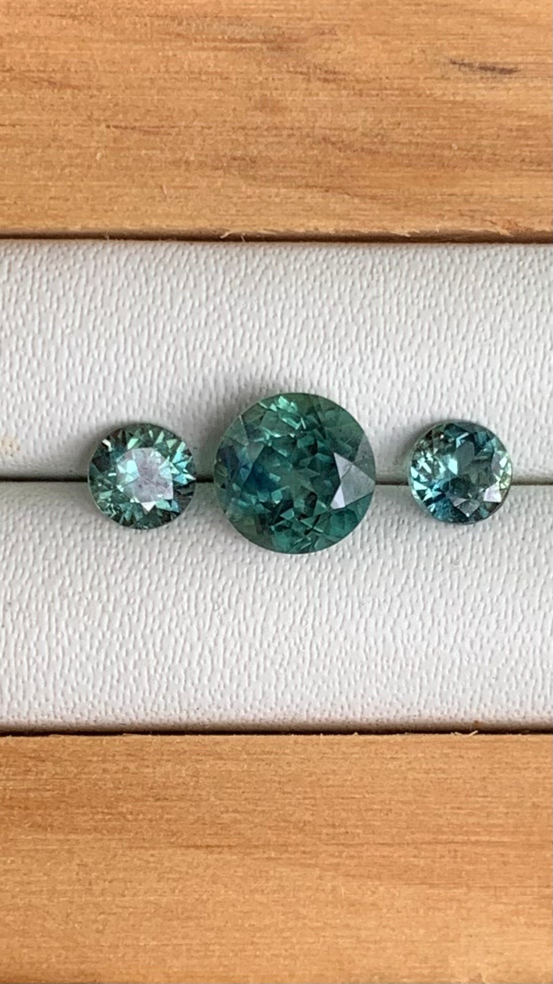 Trilogy set of teal Australian sapphire centre stone and matching accents
