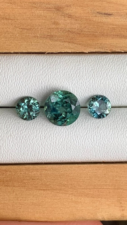 close up teal Australian sapphire centre stone and matching accents