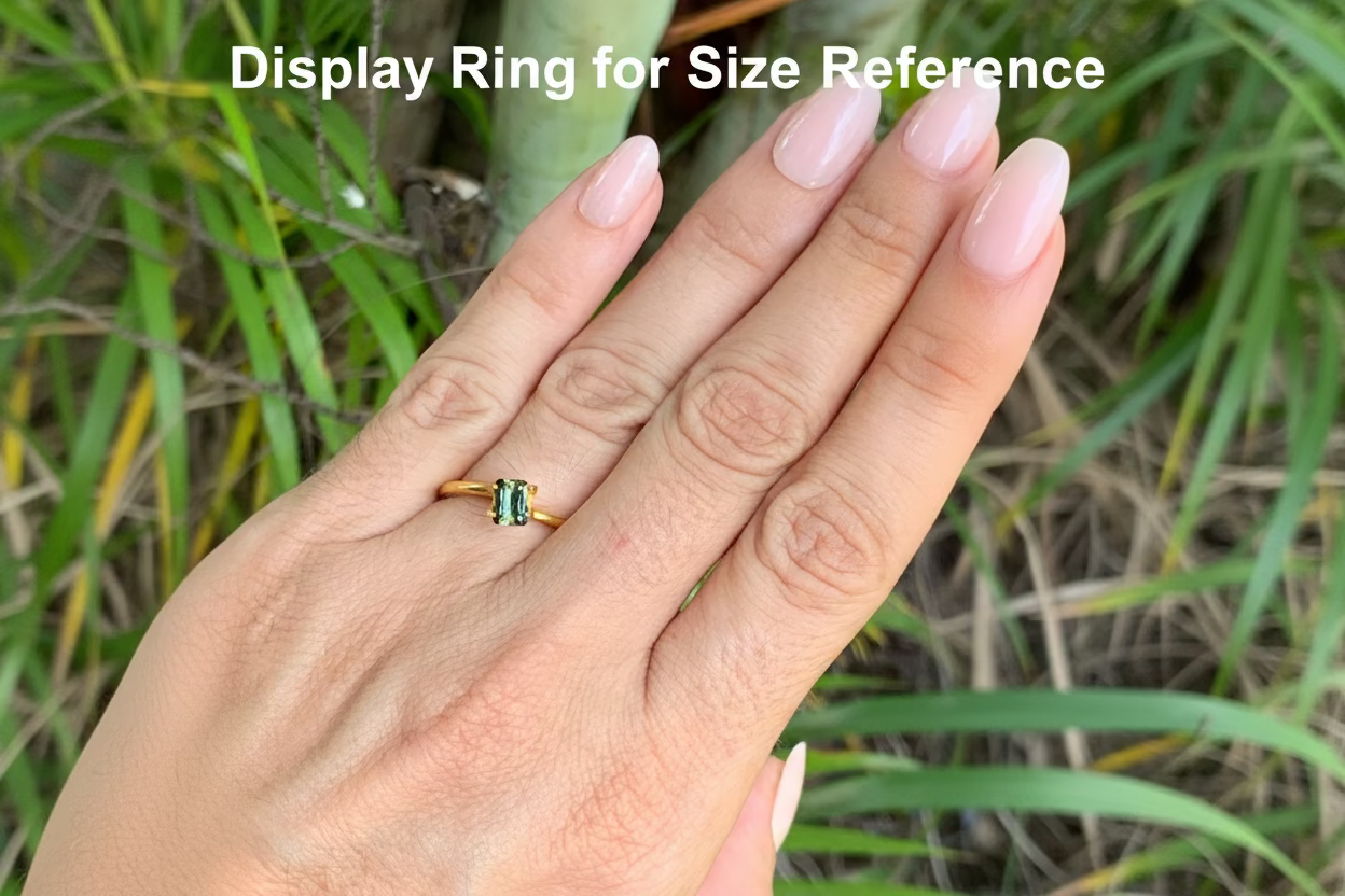 On hand photo of Australian sapphire emerald cut yellow parti stone with lengthwise zoning