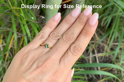 On hand photo of Australian sapphire emerald cut yellow parti stone with lengthwise zoning
