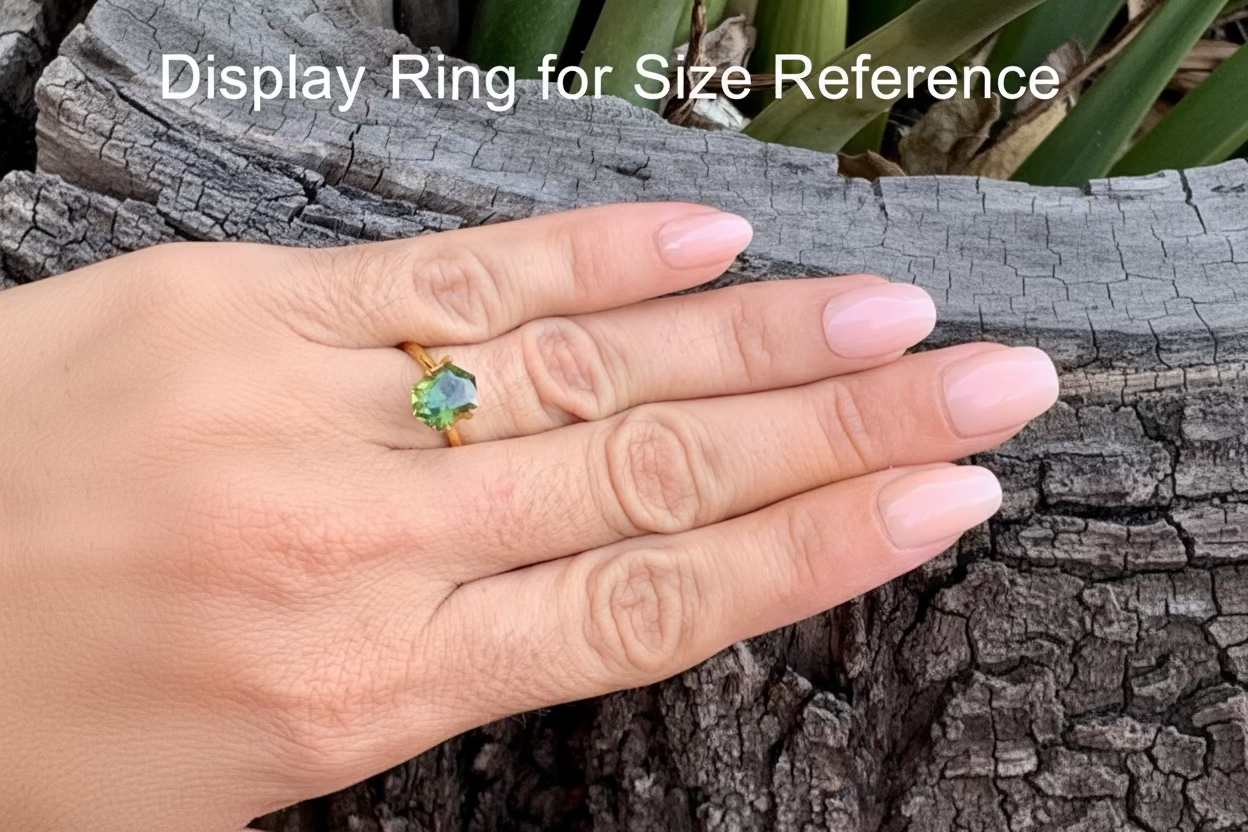 On hand photo of Australian sapphire elongated hex cut unique colour flow green yellow