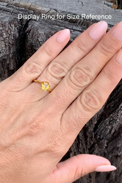 on hand photo of vivid yellow sapphire unheated Queensland gemstone cushion cut