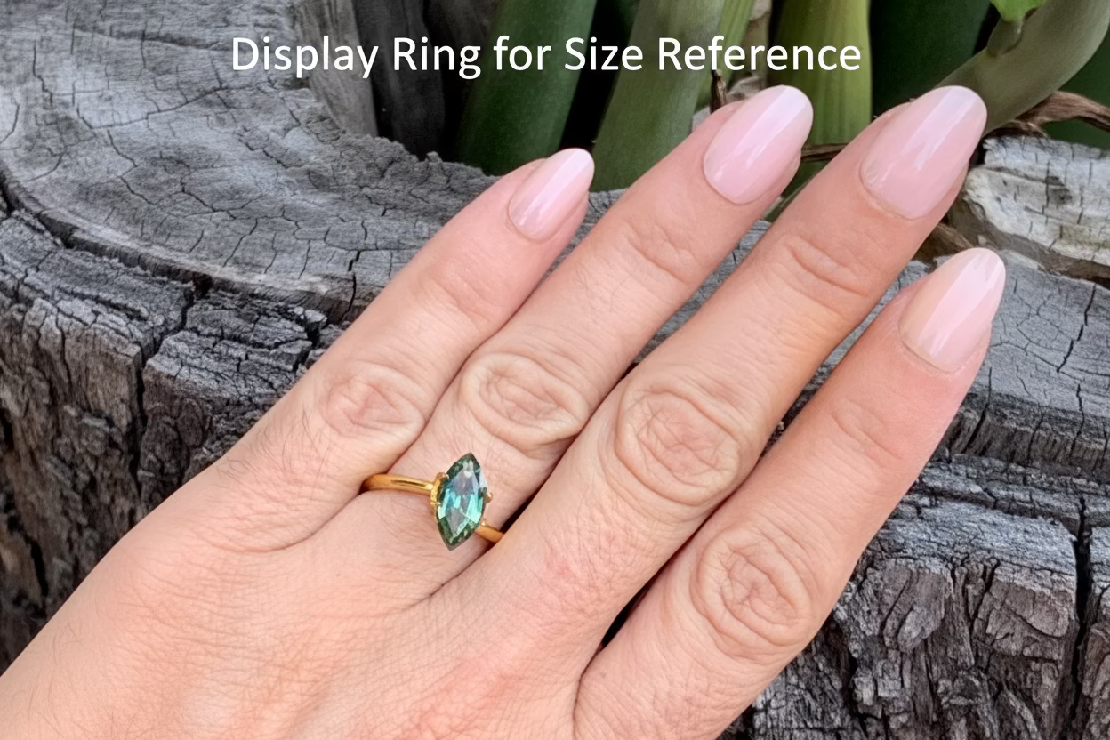on hand photo of elongated marquise Australian sapphire bright green natural gemstone 12mm