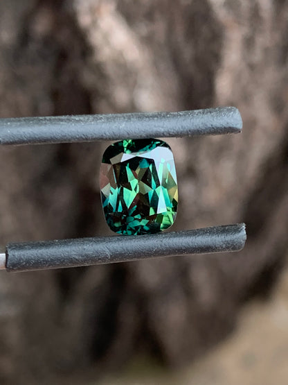 close up teal and yellow parti sapphire unheated Queensland gemstone cushion cut