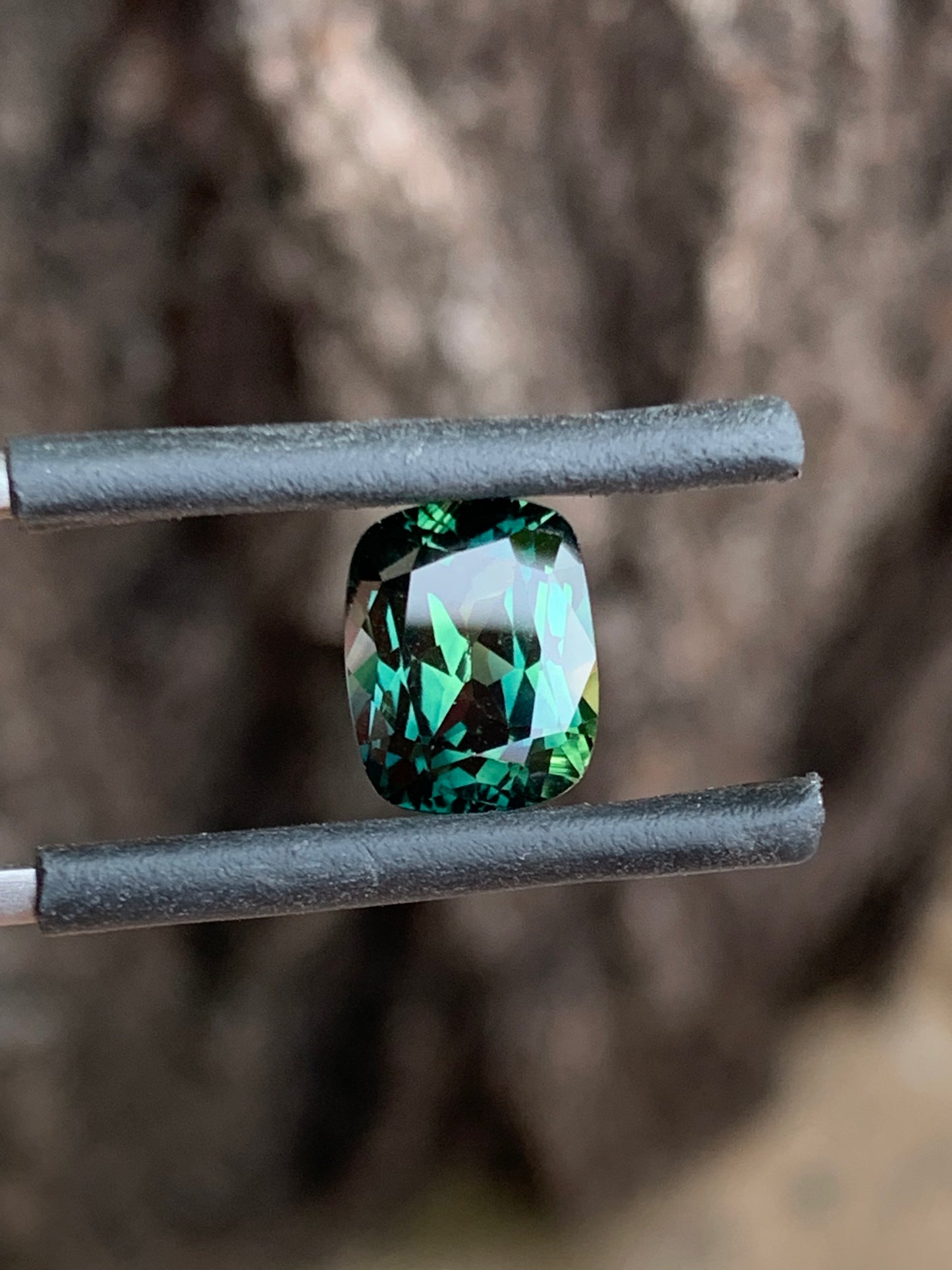 large Australian sapphire cushion cut teal parti with natural colour banding