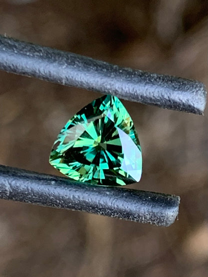 Vibrant green trillion cut Australian sapphire with brilliant sparkle