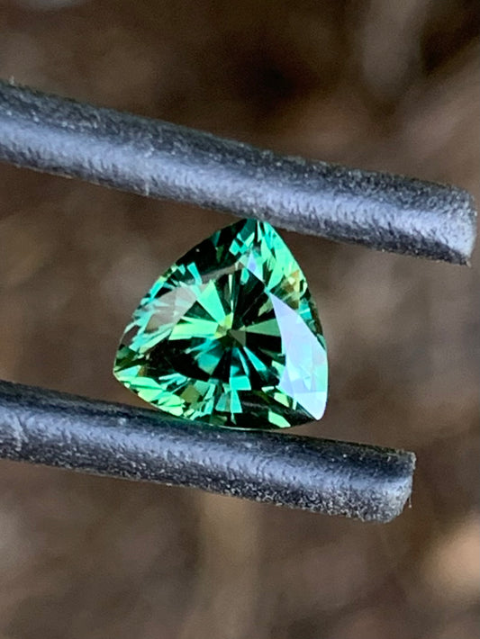 Vibrant green trillion cut Australian sapphire with brilliant sparkle