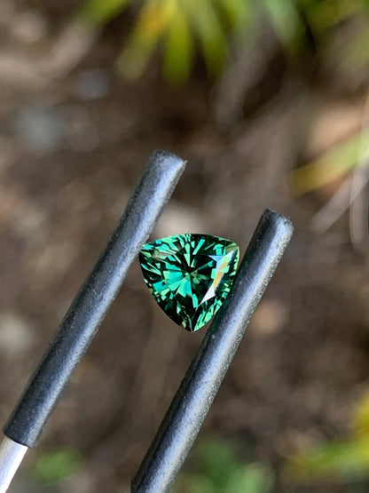 Close-up of a faceted green trillion sapphire from Australia
