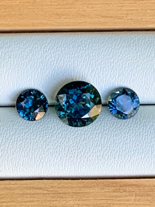 1.78ct unheated blue parti Australian sapphire trilogy set on white background