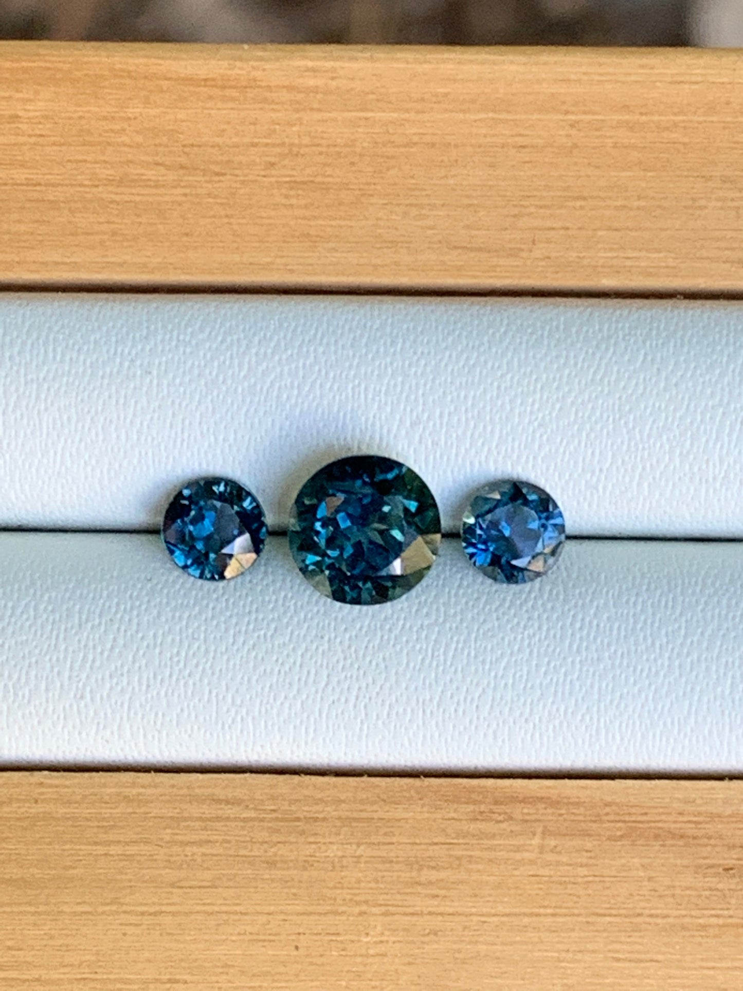 Natural Australian sapphire trilogy set with blue parti centre stone and matched accents