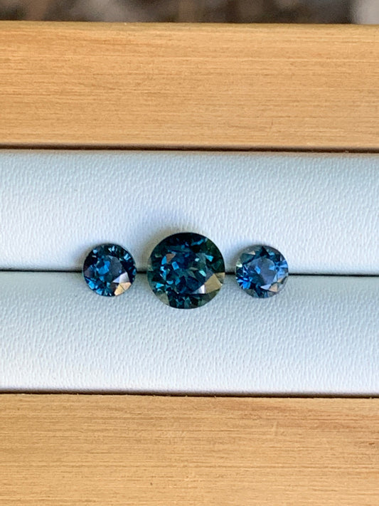 Natural Australian sapphire trilogy set with blue parti centre stone and matched accents