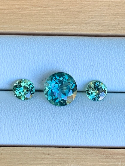 Natural Australian sapphire trilogy set with teal parti centre stone and matched accents