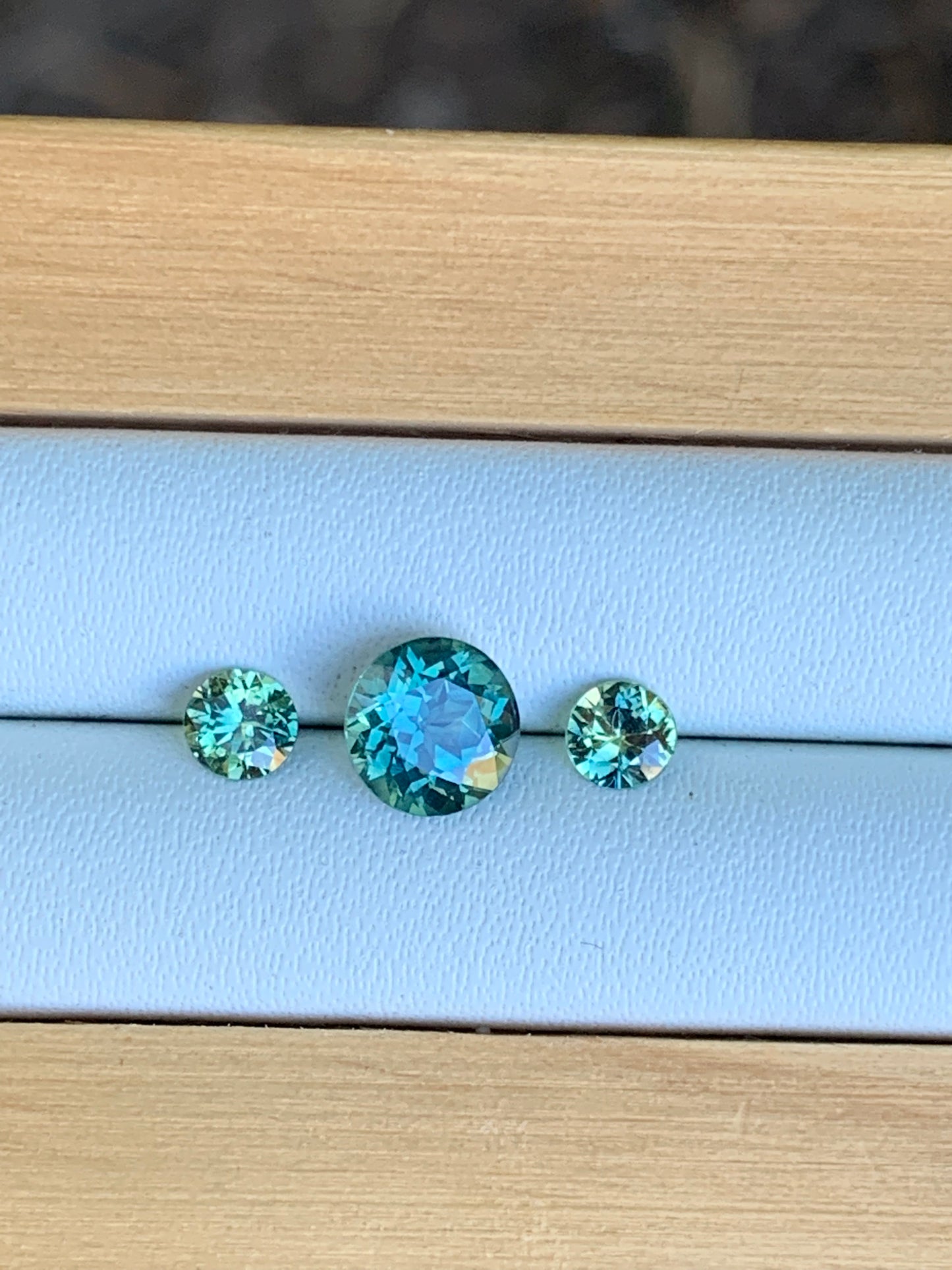 Three unheated teal parti Australian sapphires arranged for a trilogy ring