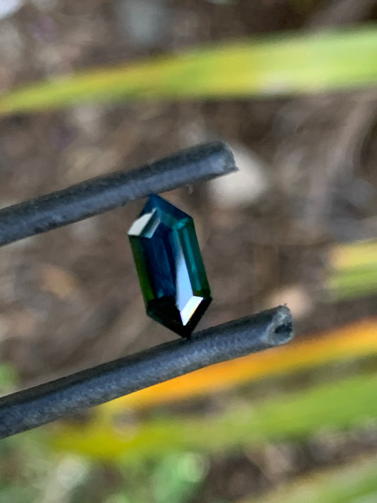 Long hexagon sapphire with deep blue colour and polished facets