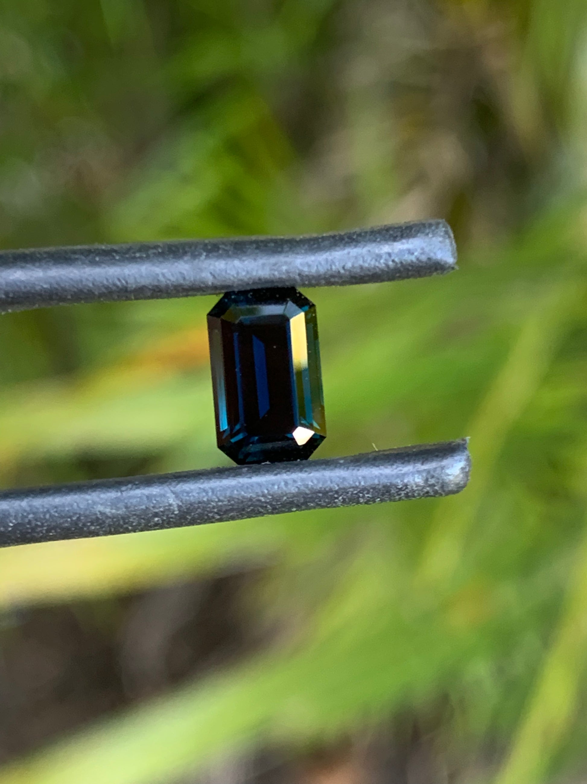 Natural heated dark blue Australian sapphire with refined step-cut facets