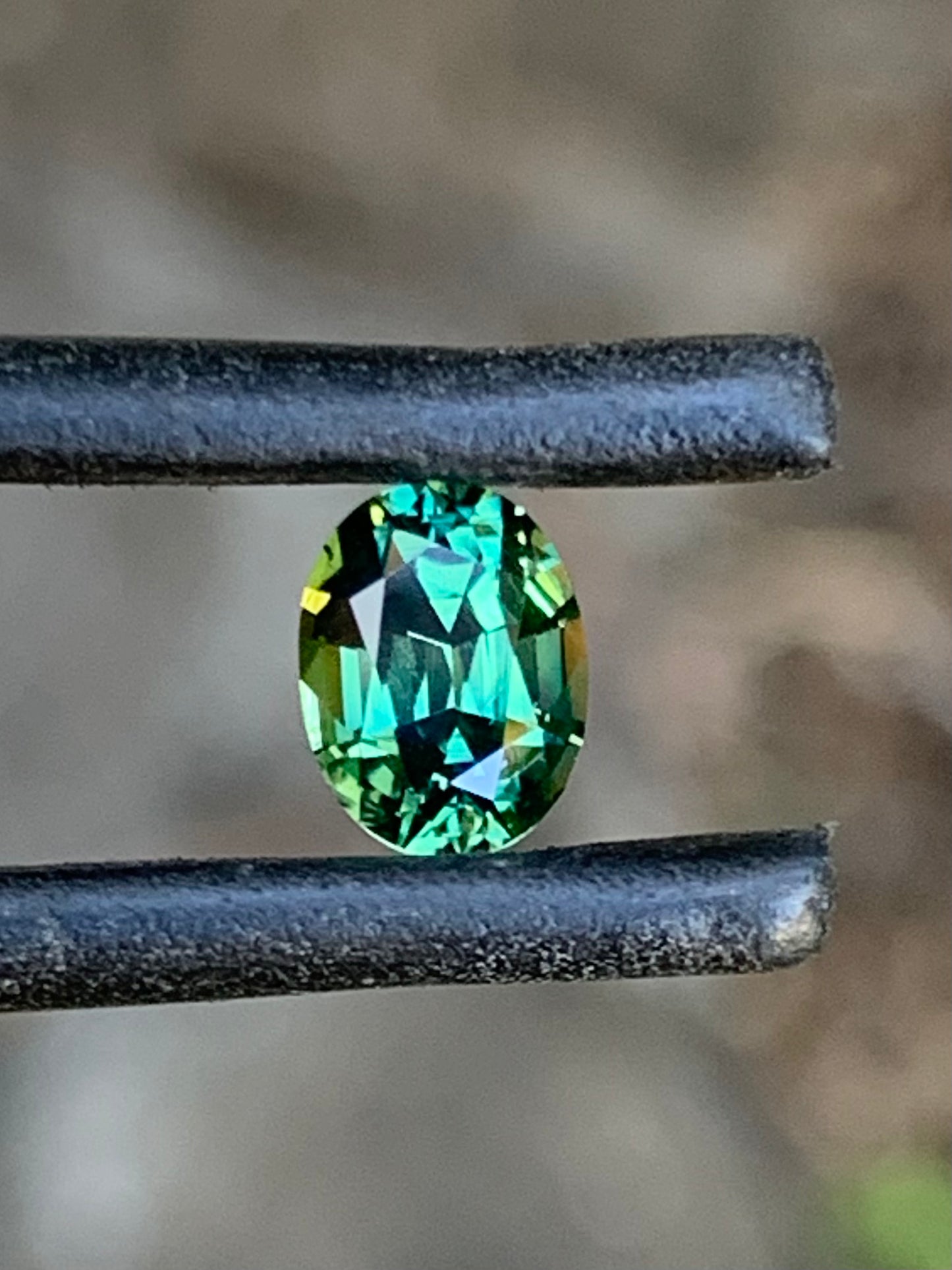 Bright green oval Australian sapphire with natural sparkle