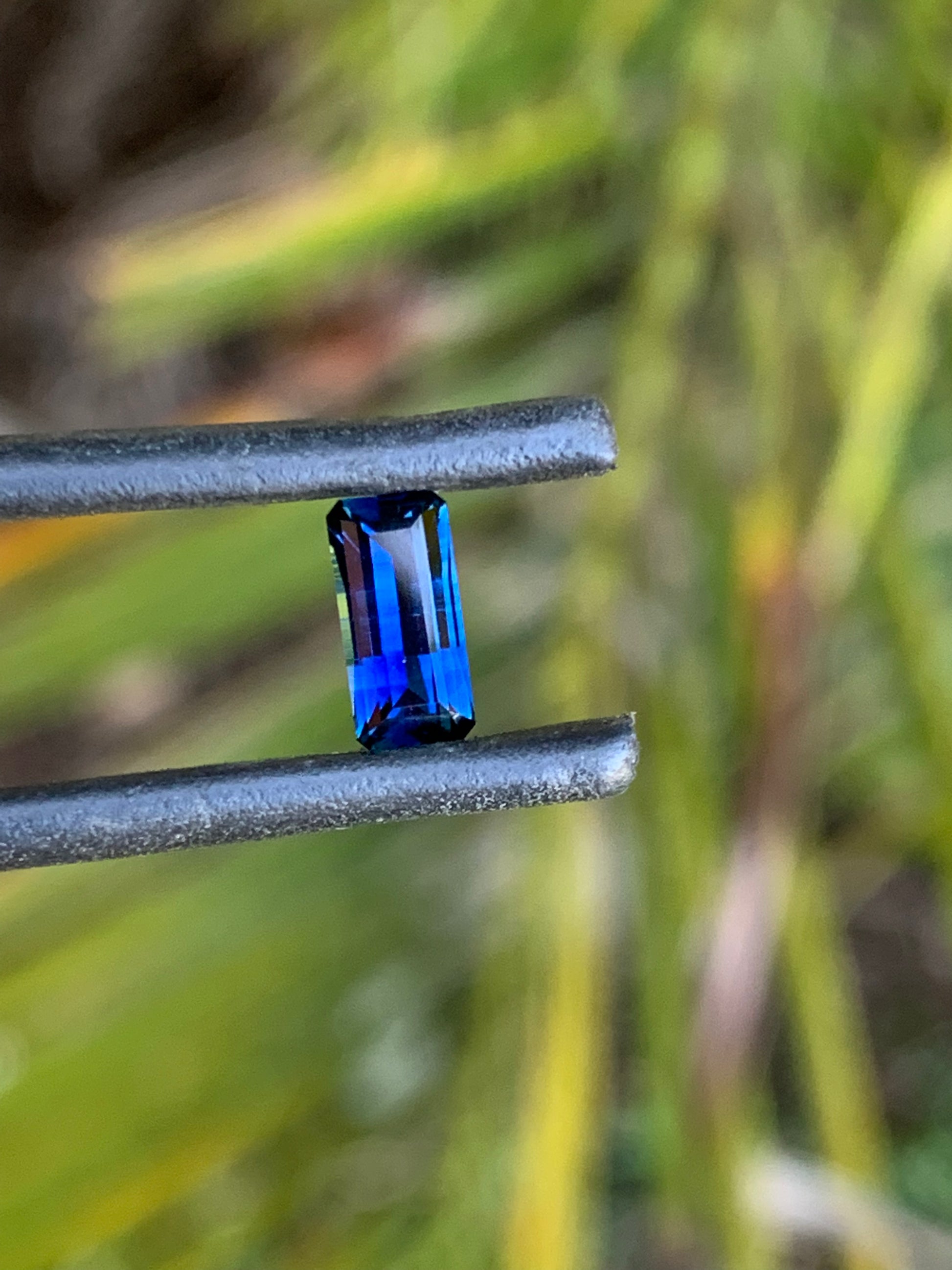 Close-up of a rich blue emerald cut sapphire from Australia