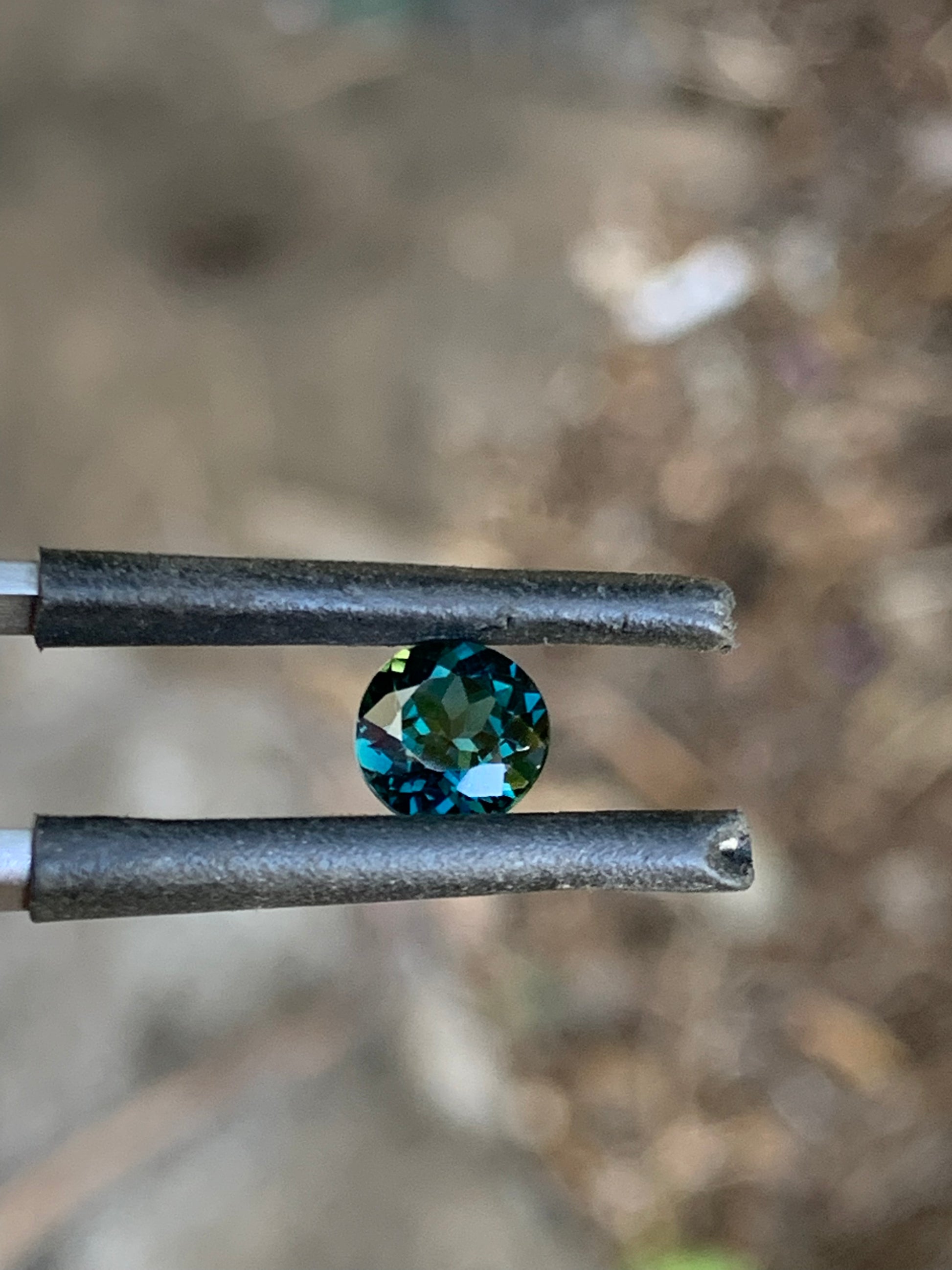 Natural Australian sapphire with teal blue colour and small yellow zone