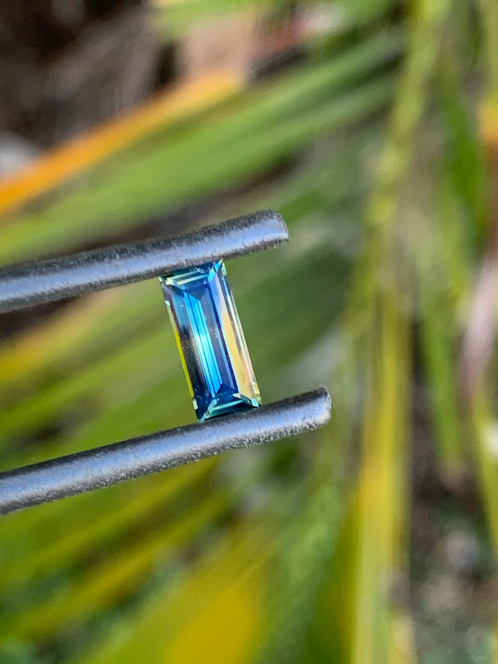 1.30ct sapphire with light blue and yellow zoning and polished facets