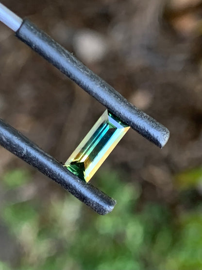 1.30ct unheated bi-colour parti Australian sapphire in a baguette cut on white background