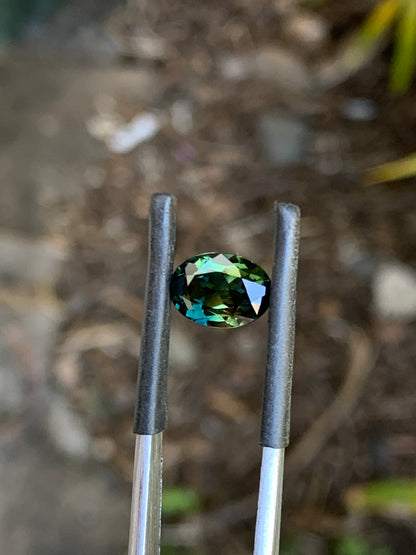 Natural oval Australian sapphire with bold teal parti colour play