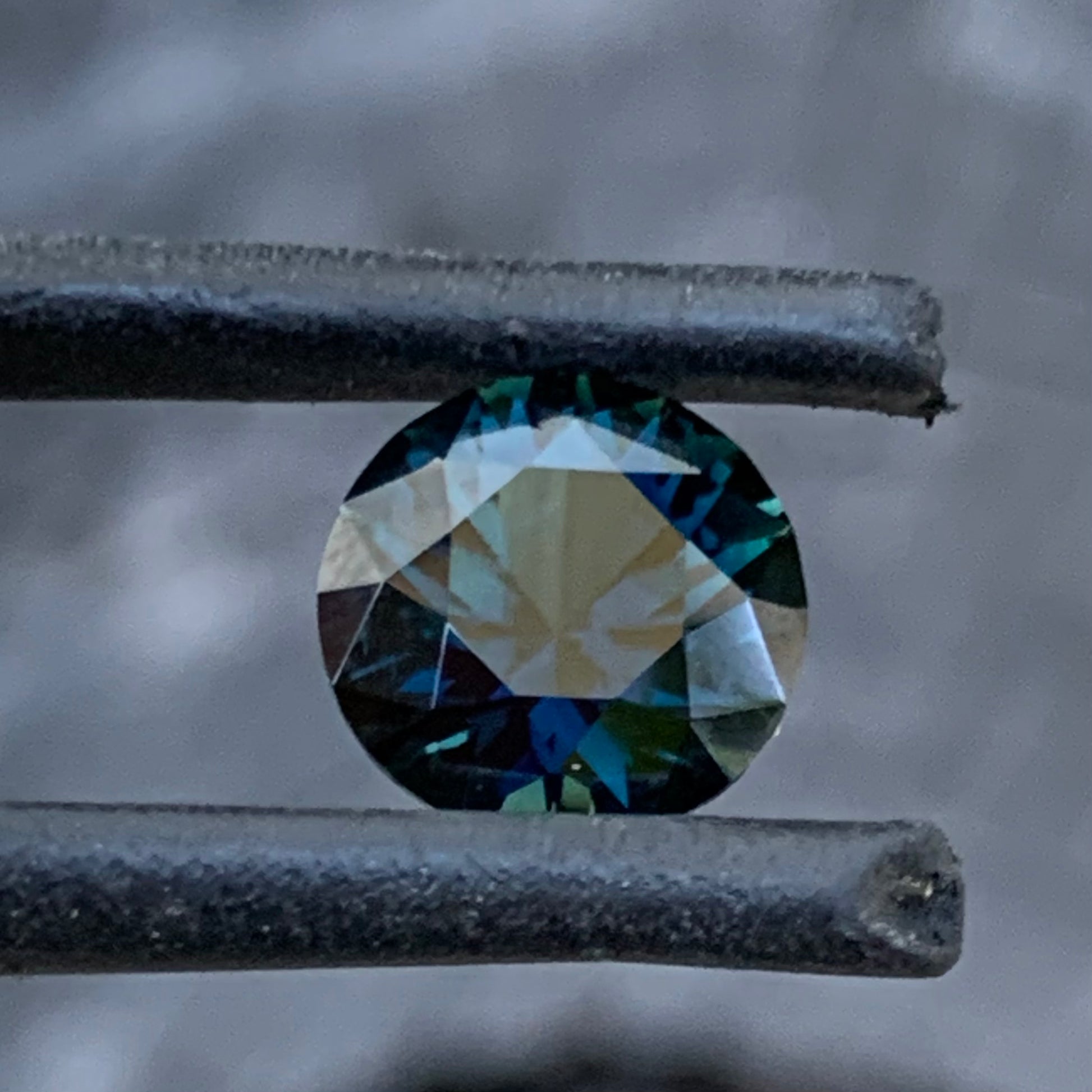 Side view of Dark blue Australian sapphire with lively flashes and natural depth