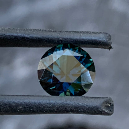 Side view of Dark blue Australian sapphire with lively flashes and natural depth