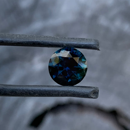 Round cut Australian sapphire showing deep blue colour and vibrant flashes